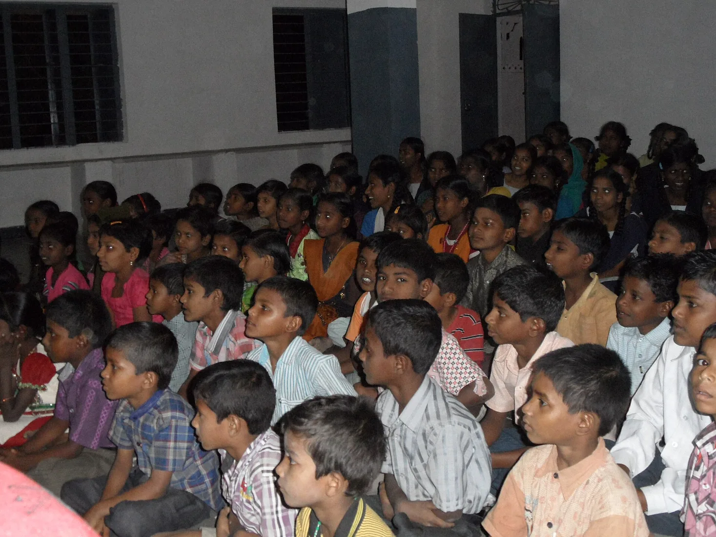 Children and community members during an education support activity